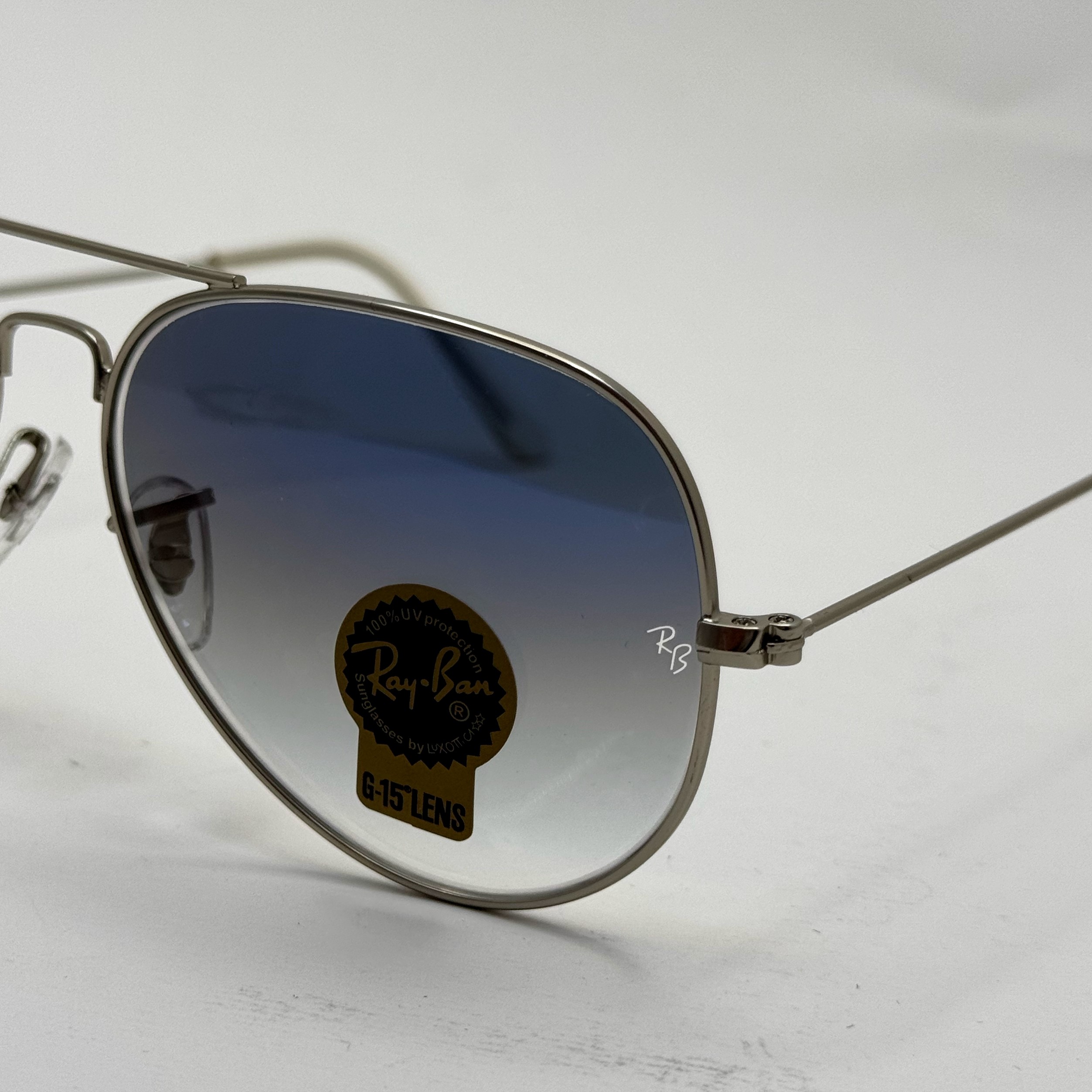 عینک ریبن خلبانی شیشه سنگ آبی هایلایت فریم نقره ای به همراه پک کامل ریبن Rayban RB 3025